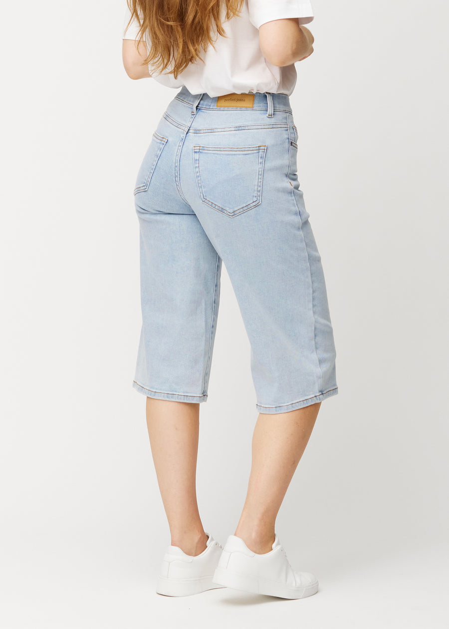 Back view of loose, light blue Waves denim capris, showing the fit and length.