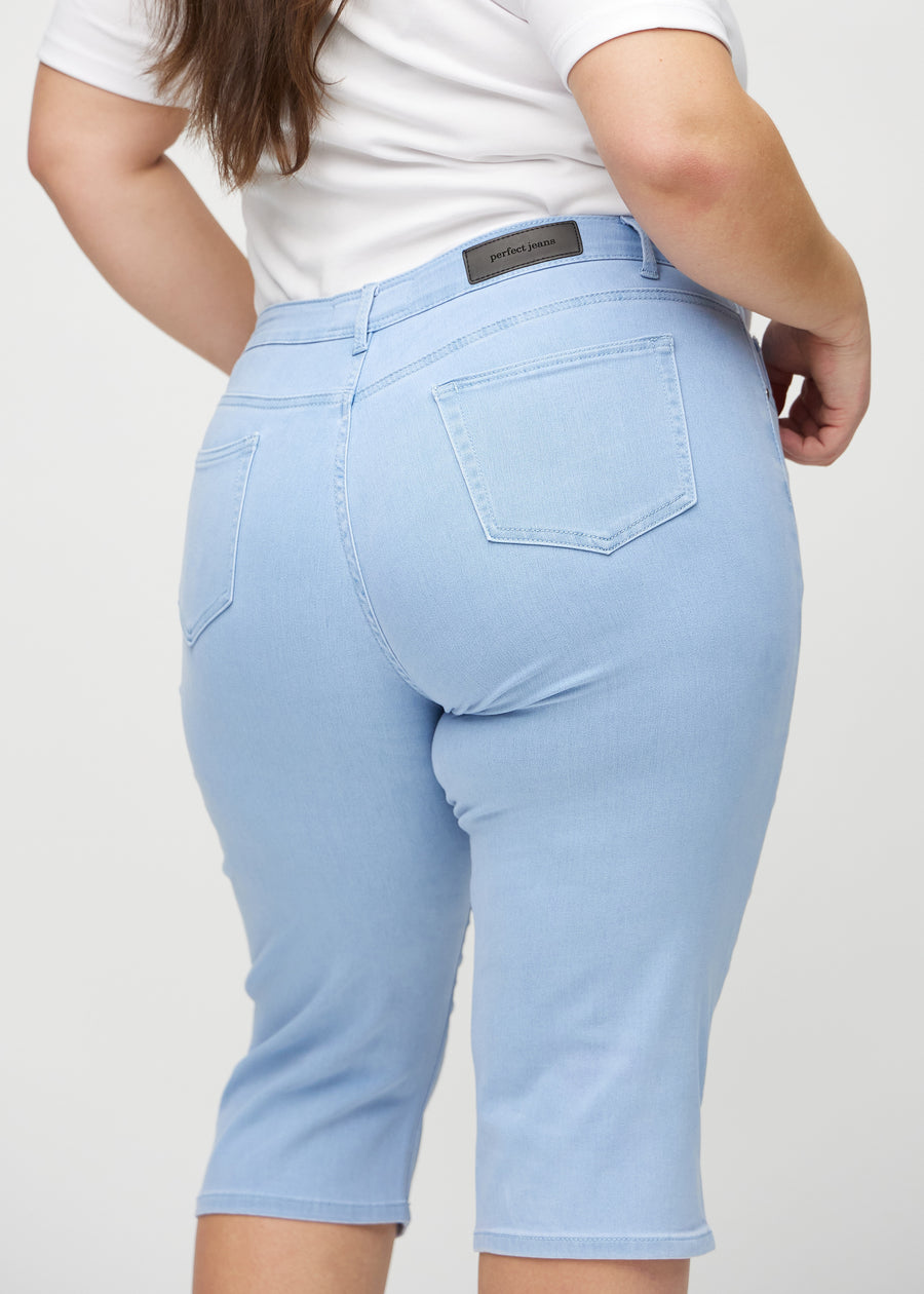Light blue regular capris seen from the back close up on a plus-size model to show details.