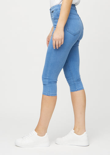 Skinny capris for women in blue fabric, color Geraniums. Side view on a model, showing the fitted cut.