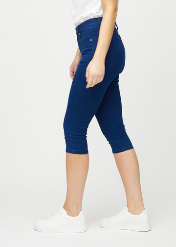 Skinny capris for women in dark blue fabric, color Royals. Side view on a model, showing the fitted cut.