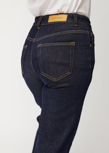 Deep dark blue denim jeans for women in the colour Midnights seen from the back in close up to show fit and details.