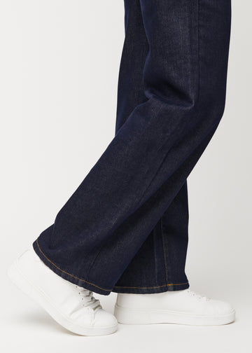 Deep dark blue denim jeans for women in the colour Midnights with a loose fit shown close up at the ankles to show the wide finish.