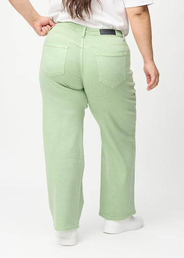 Loose jeans for women in light green, color Mints. Back view on a plus-size model, showing the overall relaxed fit.