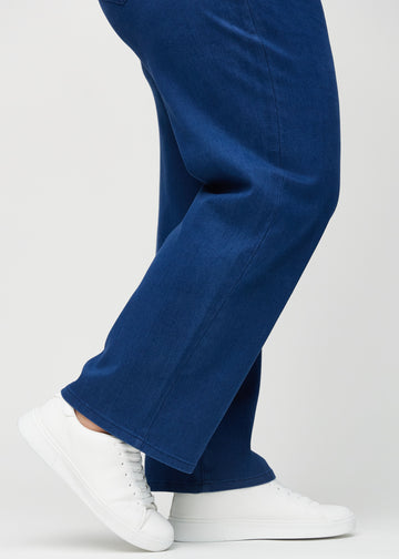 The ankles of a plus-size model, so you can see how loose the jeans fit.