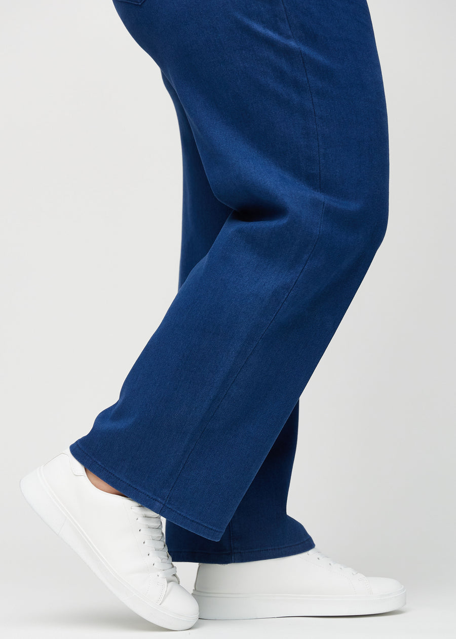 The ankles of a plus-size model, so you can see how loose the jeans fit.