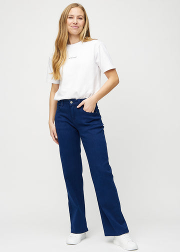 Full image of a model in dark blue loose jeans.