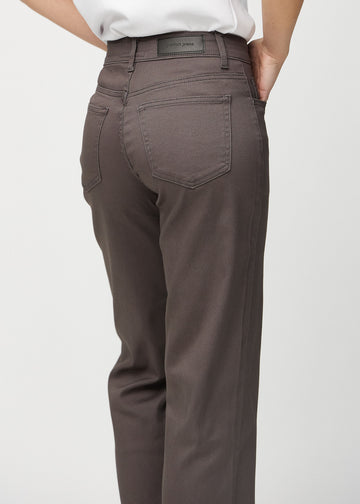 Grey-brown loose jeans seen from behind close up to show details.