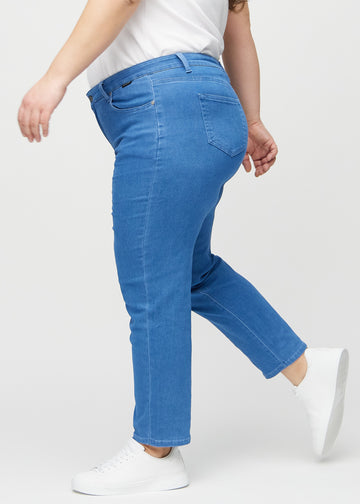 Regular jeans for women in blue, color Geraniums. Side view on a plus-size model.