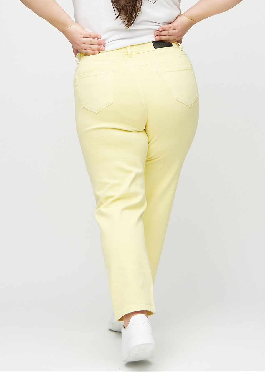 Regular jeans for women in light yellow, color Lemonades. Back view on a plus-size model, showing the full fit.