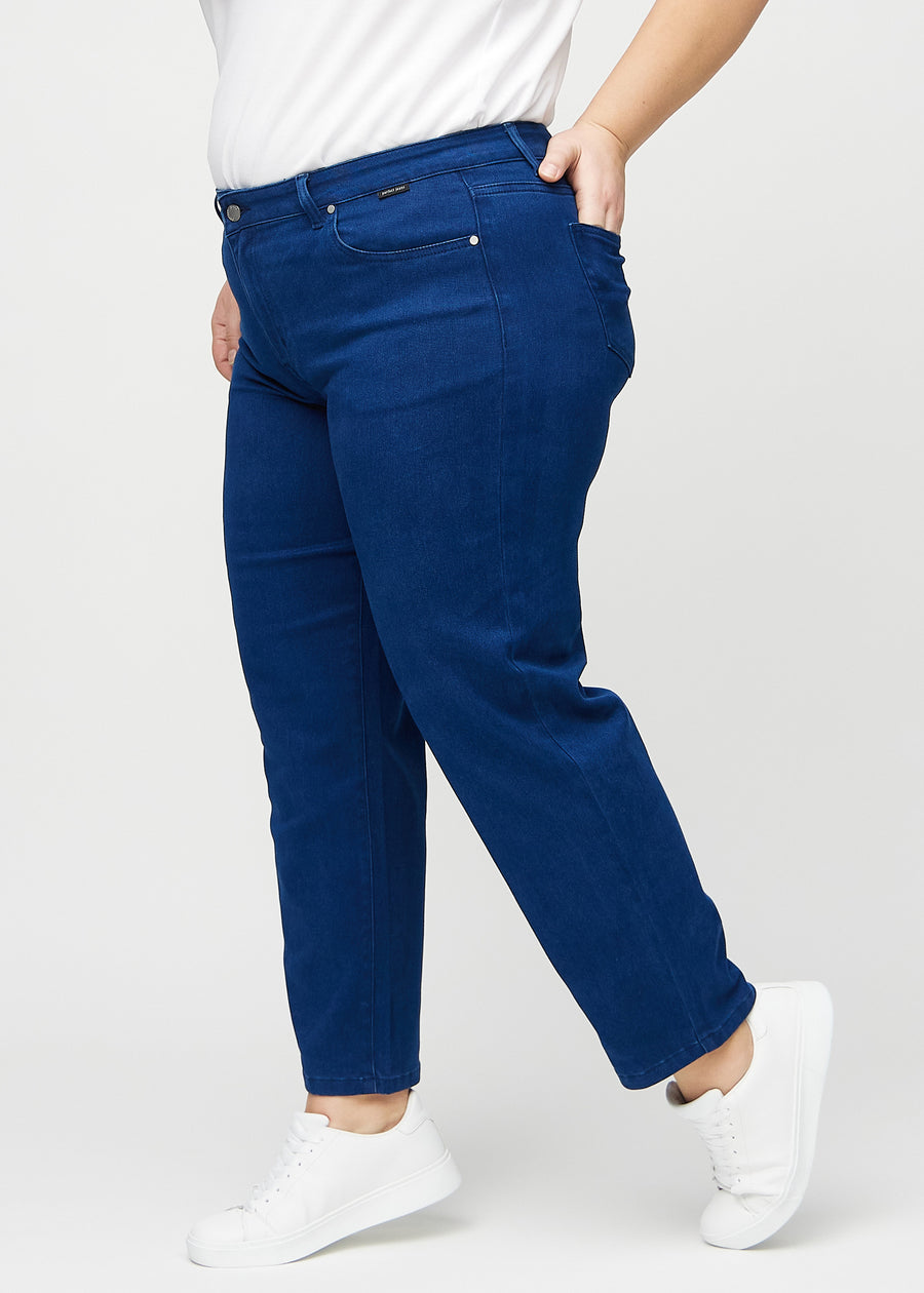 Regular jeans for women in dark blue, color Royals. Side view on a plus-size model.