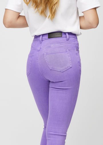 Skinny jeans for women in purple, color Lavenders. Close-up back view on a model, showing details.