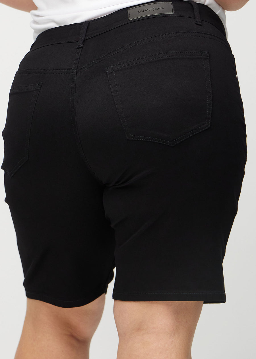 Black regular middle shorts seen from the back close up on a plus-size model to show details.