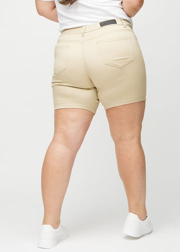 Beige skinny short shorts seen from the back on a plus-size model, so the entire product is visible.