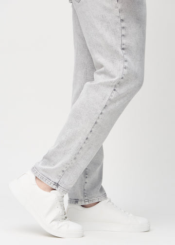 The ankles of a plus-size model, so you can see how loose the jeans fit.