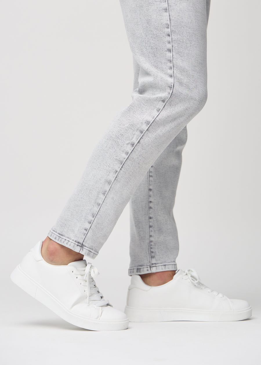 The ankles of a model, so you can see how loose the jeans fit.