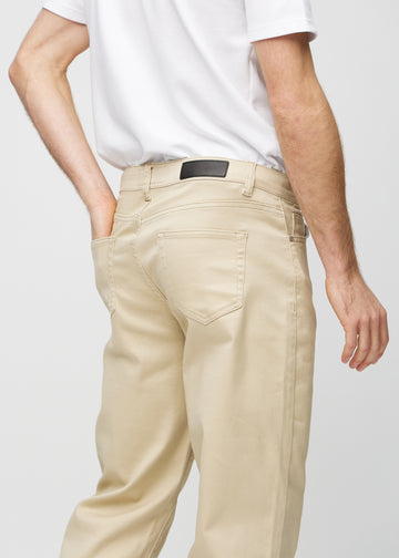 Beige regular jeans seen from the back up close to show details.