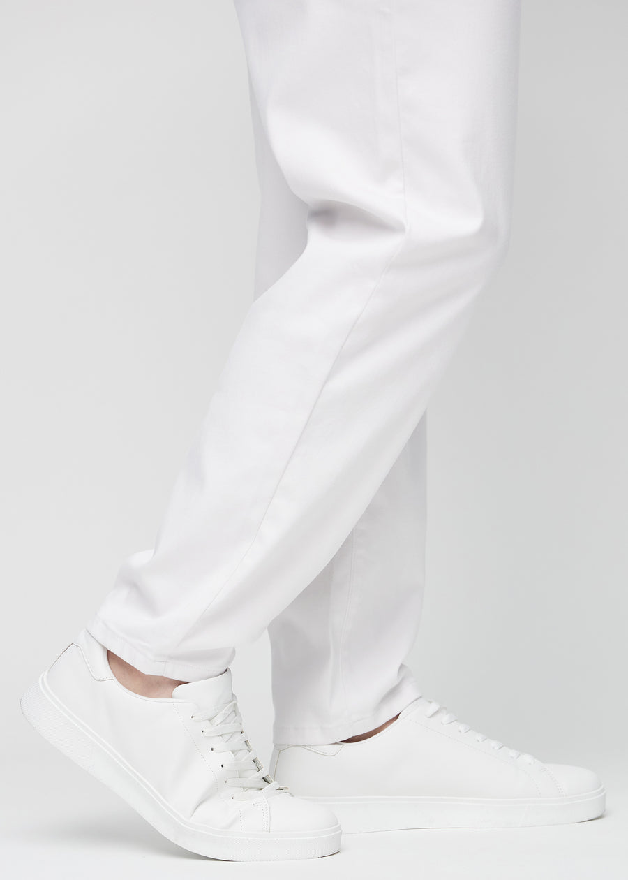 The ankles of a plus-size model, so you can see how loose the jeans fit.