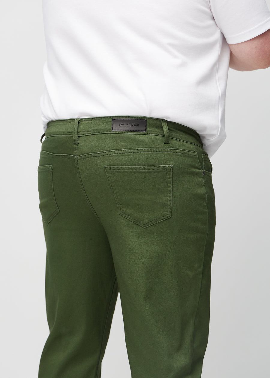 Dark green regular jeans seen from the back close up on a plus-size model to show details.