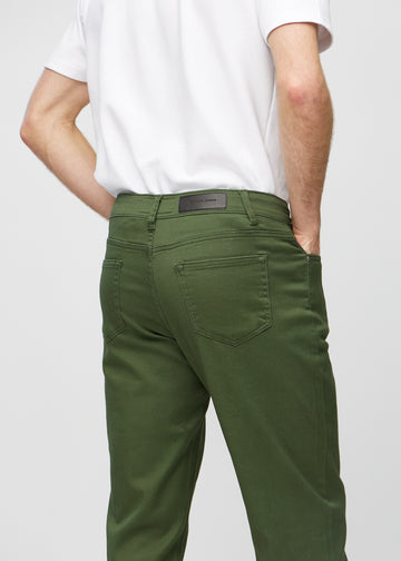 Dark green regular jeans seen from the back close up to show details.