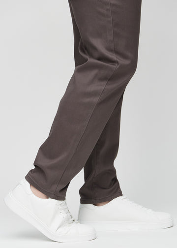 The ankles of a plus-size model, so you can see how loose the jeans fit.