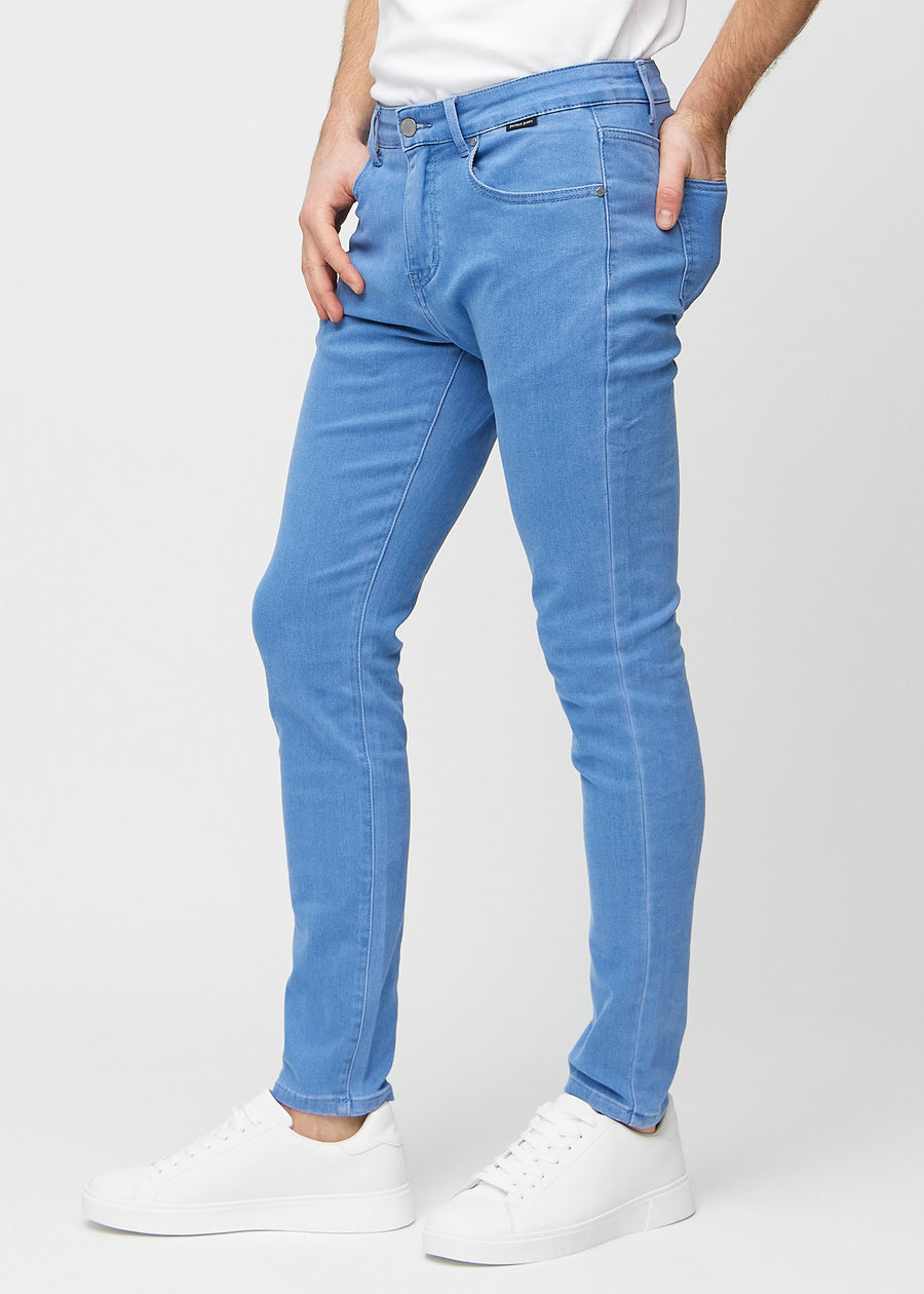 Blue slim jeans viewed from the side on a model.