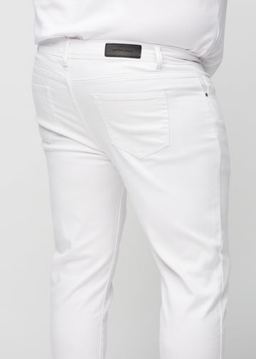 Close-up back view of white slim jeans on a plus-size model showing details.