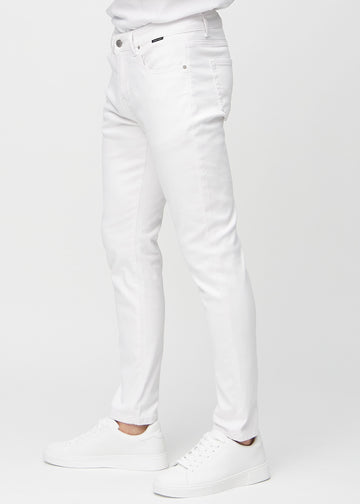White slim jeans viewed from the side on a model.